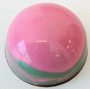 raspberry pistachio shelled in 54% dark chocolate bonbon